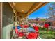 Covered patio with red chairs and a table, ideal for outdoor dining at 5911 Corbin Ave, Las Vegas, NV 89122