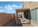 Covered patio and seating area in backyard at 6271 Port Astoria Ct, Las Vegas, NV 89122