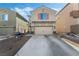 Two-story house with beige siding, a two-car garage, and landscaping at 6271 Port Astoria Ct, Las Vegas, NV 89122