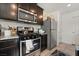 Kitchen with stainless steel appliances and dark wood cabinets at 6271 Port Astoria Ct, Las Vegas, NV 89122