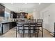 Modern kitchen with dark cabinetry, granite countertops, and stainless steel appliances at 6271 Port Astoria Ct, Las Vegas, NV 89122