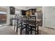 Modern kitchen with dark wood cabinets, granite counters, and island seating at 6271 Port Astoria Ct, Las Vegas, NV 89122