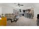 Open concept living room with a view into the kitchen and a ceiling fan at 6271 Port Astoria Ct, Las Vegas, NV 89122