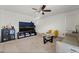 Living room featuring a large TV, comfortable seating, and a coffee table at 6271 Port Astoria Ct, Las Vegas, NV 89122