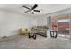 Living room with a sofa, chair, coffee table, and sliding glass door access to a patio at 6271 Port Astoria Ct, Las Vegas, NV 89122
