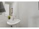 Modern powder room with pedestal sink and mirror at 6271 Port Astoria Ct, Las Vegas, NV 89122