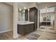 Double vanity bathroom with a large mirror and modern lighting at 10758 Chillingham Dr, Las Vegas, NV 89183