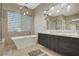 Bathroom boasts a free-standing tub and modern double vanity at 10758 Chillingham Dr, Las Vegas, NV 89183