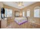 Relaxing bedroom with hanging chair and large mirror at 10758 Chillingham Dr, Las Vegas, NV 89183