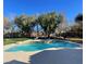 Inviting swimming pool with a waterfall feature surrounded by trees at 10758 Chillingham Dr, Las Vegas, NV 89183