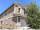 Two-story house with attached garage, stone accents, and tree at 112 Antler Square Ln, Henderson, NV 89011