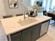 Kitchen island with sink, seating, and white countertop at 112 Antler Square Ln, Henderson, NV 89011