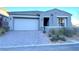 Single-story home with gray exterior, two-car garage, and landscaped front yard at 32 Honeymoon Dr, Henderson, NV 89011