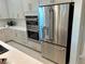 Stainless steel refrigerator and double oven in a modern kitchen setting at 32 Honeymoon Dr, Henderson, NV 89011