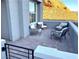 Covered patio with brick pavers and comfortable seating, overlooking mountain views at 32 Honeymoon Dr, Henderson, NV 89011