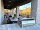 Covered patio with outdoor kitchen, fire pit, and mountain views at 32 Honeymoon Dr, Henderson, NV 89011