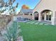 Landscaped backyard with artificial turf and a fire pit at 36 Honeymoon Dr, Henderson, NV 89011