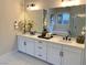 Double vanity bathroom with white cabinets and marble floors at 36 Honeymoon Dr, Henderson, NV 89011