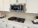 Gas cooktop and microwave installed in white shaker cabinets at 36 Honeymoon Dr, Henderson, NV 89011