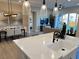 Kitchen island with sink and seating overlooks dining area at 36 Honeymoon Dr, Henderson, NV 89011