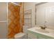 Bright bathroom with unique tile shower, white toilet and vanity with a sink at 5409 Centurion Ct # 104, Las Vegas, NV 89122