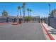 Gated entrance to the Duck Creek Village community with mature palm trees on a sunny day at 5409 Centurion Ct # 104, Las Vegas, NV 89122