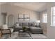Staged living room with ample natural light, neutral decor, and modern furnishings at 5409 Centurion Ct # 104, Las Vegas, NV 89122