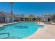 Community pool features clean, blue water and a covered lounge area for relaxation at 5409 Centurion Ct # 104, Las Vegas, NV 89122