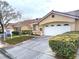 Beige house with a two-car garage and well-maintained landscaping at 6409 Sierra Diablo Ave, Las Vegas, NV 89130