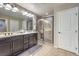 This bathroom features double sinks and a tiled shower at 6482 Twin Harbors Ct, Las Vegas, NV 89141