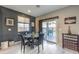 Dining area with modern table, chairs, and sliding glass doors to the outdoor space at 6482 Twin Harbors Ct, Las Vegas, NV 89141