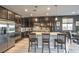 Modern kitchen featuring stainless steel appliances, dark cabinets, and a spacious island at 6482 Twin Harbors Ct, Las Vegas, NV 89141