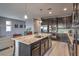 Modern kitchen with stainless steel appliances, granite countertops and dark wood cabinetry at 6482 Twin Harbors Ct, Las Vegas, NV 89141