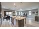 Open-concept kitchen featuring granite counters, stainless appliances, and island with seating at 6482 Twin Harbors Ct, Las Vegas, NV 89141