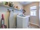 The well organized laundry room has a window for natural light at 6482 Twin Harbors Ct, Las Vegas, NV 89141