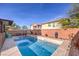 A fenced, in-ground pool features desert landscaping and outdoor furniture at 6482 Twin Harbors Ct, Las Vegas, NV 89141