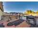 Backyard deck featuring a picnic table, grill, and view of the expansive yard at 7320 Bath Dr, Las Vegas, NV 89131