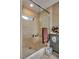 Tiled walk-in shower with glass door and built-in shelving at 7320 Bath Dr, Las Vegas, NV 89131