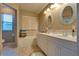 Bright bathroom with double sinks, bathtub, and tiled floors at 7320 Bath Dr, Las Vegas, NV 89131