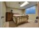 Bedroom featuring a bed, dresser, and window with blinds at 7320 Bath Dr, Las Vegas, NV 89131