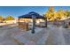 A cozy backyard gazebo with comfortable seating and decorative paving stones for outdoor relaxation at 7320 Bath Dr, Las Vegas, NV 89131