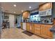 Kitchen featuring wooden cabinets, a window over the sink, and tile floors at 7320 Bath Dr, Las Vegas, NV 89131