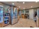 Bright kitchen with stainless steel refrigerator and tile flooring at 7320 Bath Dr, Las Vegas, NV 89131