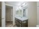 Well-lit bathroom features a single sink vanity, large mirror, and modern fixtures at 8455 W Sahara Ave # 154, Las Vegas, NV 89117