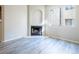 Living room view showcasing a fireplace, a large window, and wood-look floors for a modern touch at 8455 W Sahara Ave # 154, Las Vegas, NV 89117