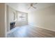 Bright living room featuring a cozy fireplace, large window, and modern wood-look flooring at 8455 W Sahara Ave # 154, Las Vegas, NV 89117