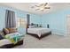 Spacious bedroom with king bed and light blue walls at 9494 Alma Ridge Ave, Las Vegas, NV 89178