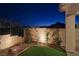 Landscaped backyard with artificial turf and mountain views at 144 Juliette Pointe Ln, Henderson, NV 89011