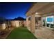 Landscaped backyard with artificial turf and night lighting at 144 Juliette Pointe Ln, Henderson, NV 89011