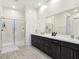 Spa-like bathroom with double vanity, large mirror, and walk-in shower at 144 Juliette Pointe Ln, Henderson, NV 89011